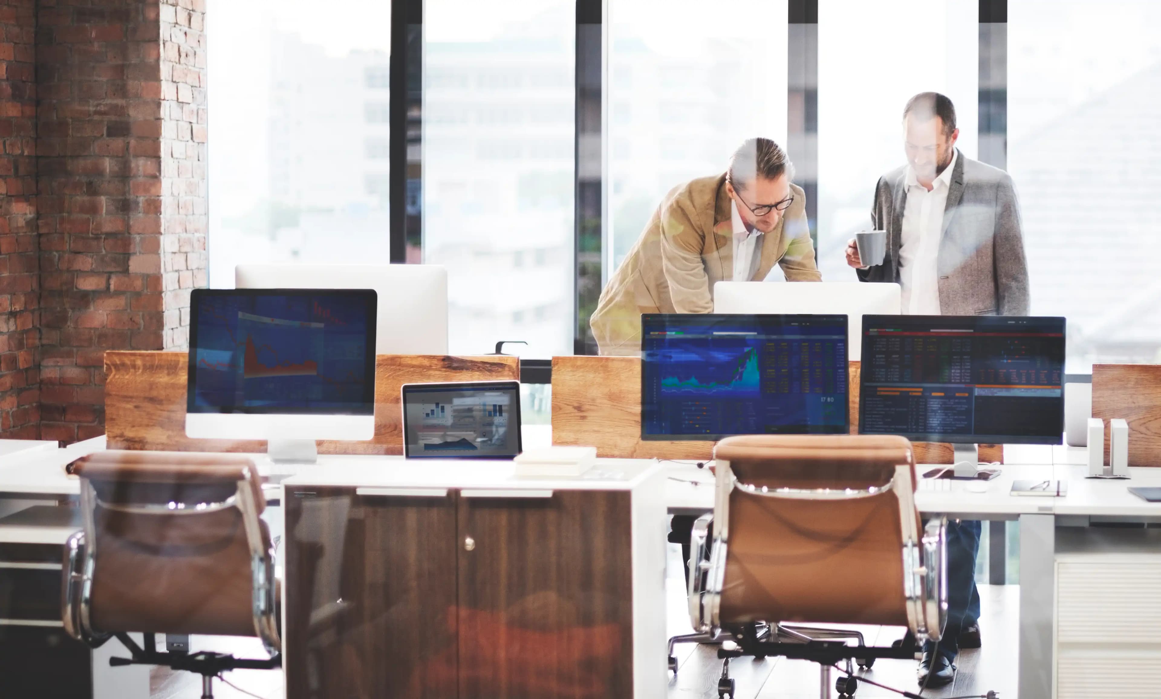 IT specialists immersed in their work, surrounded by technology in a modern office setting, where innovation meets efficiency.