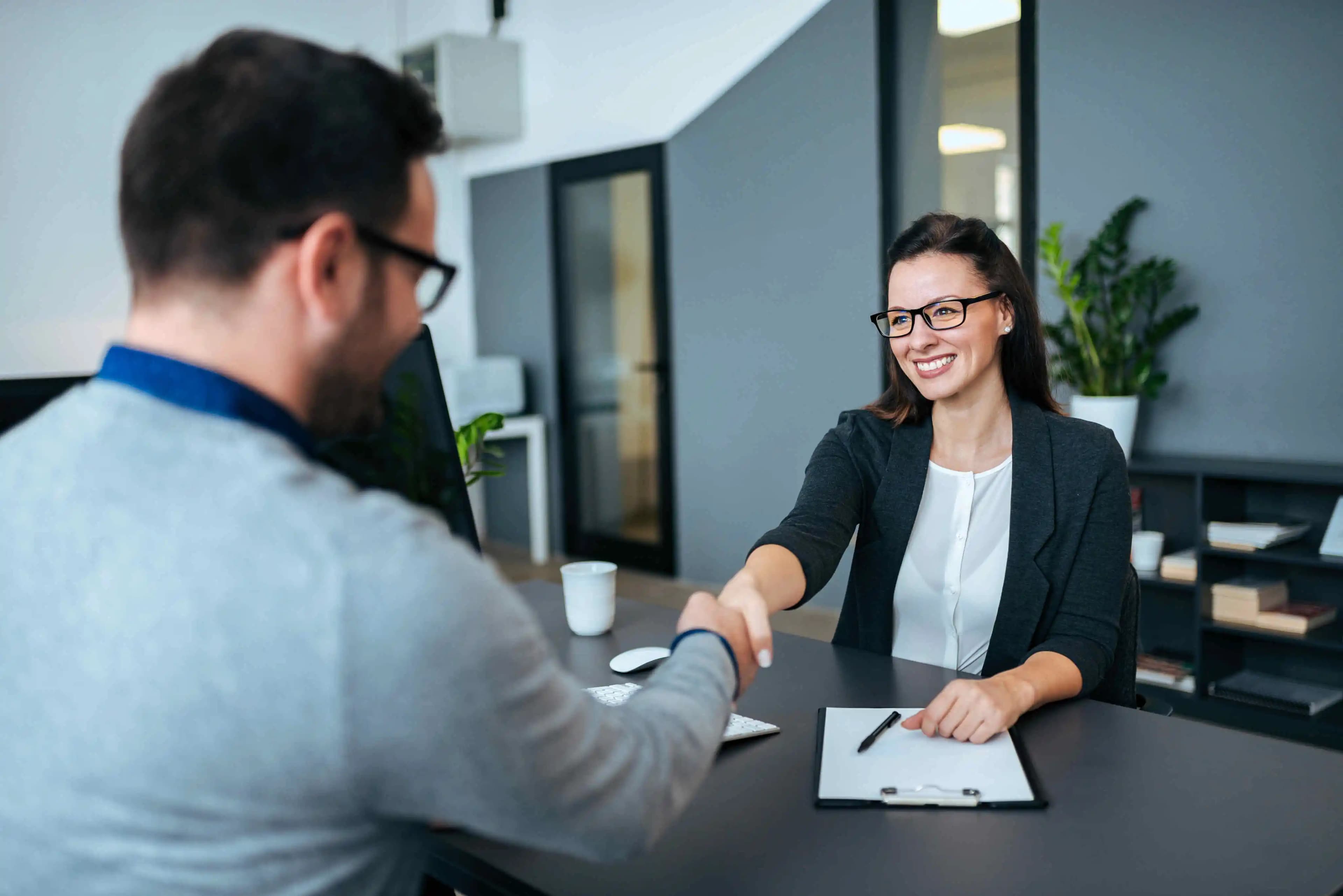 IT specialists immersed in their work, surrounded by technology in a modern office setting, where innovation meets efficiency.