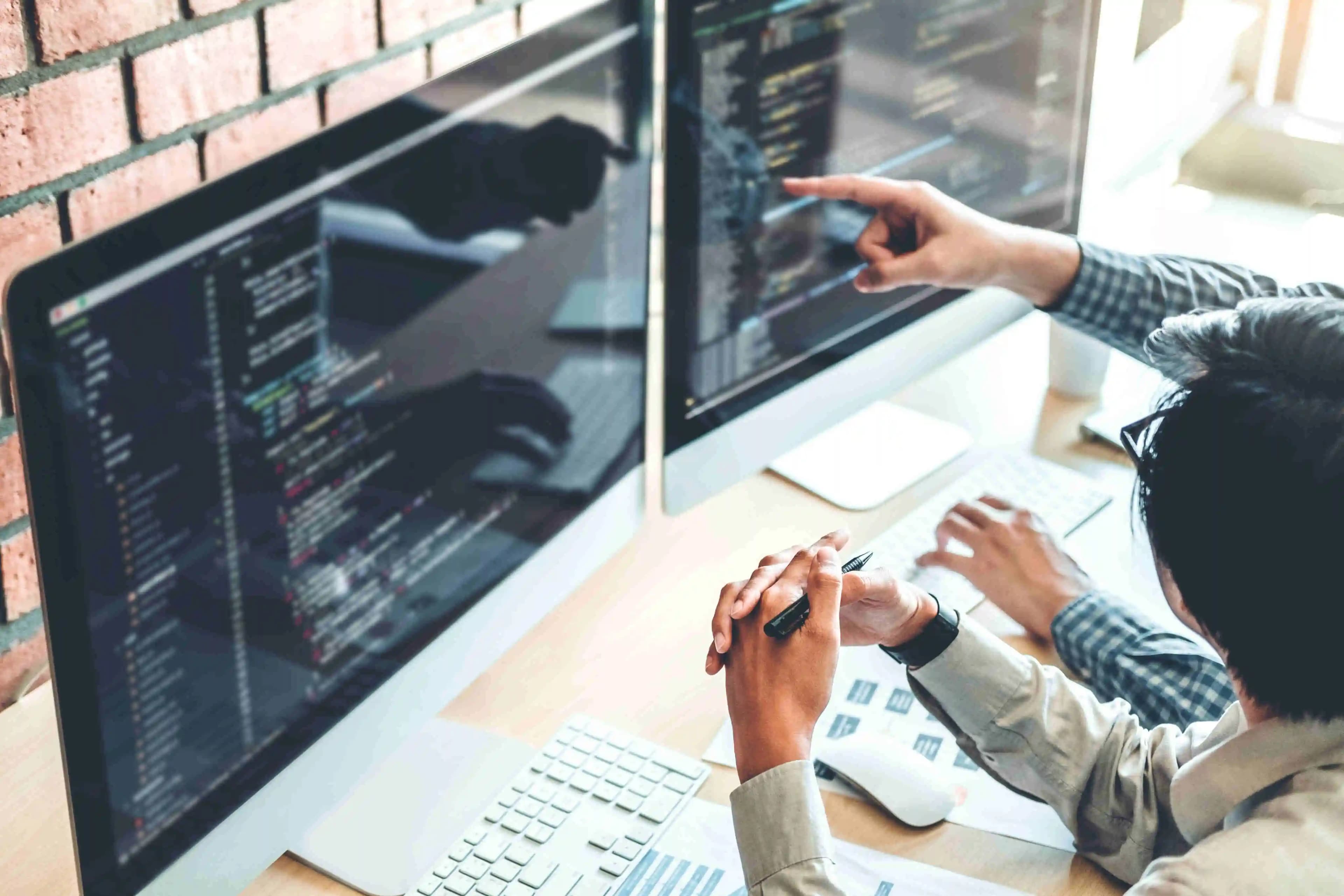 IT specialists immersed in their work, surrounded by technology in a modern office setting, where innovation meets efficiency.