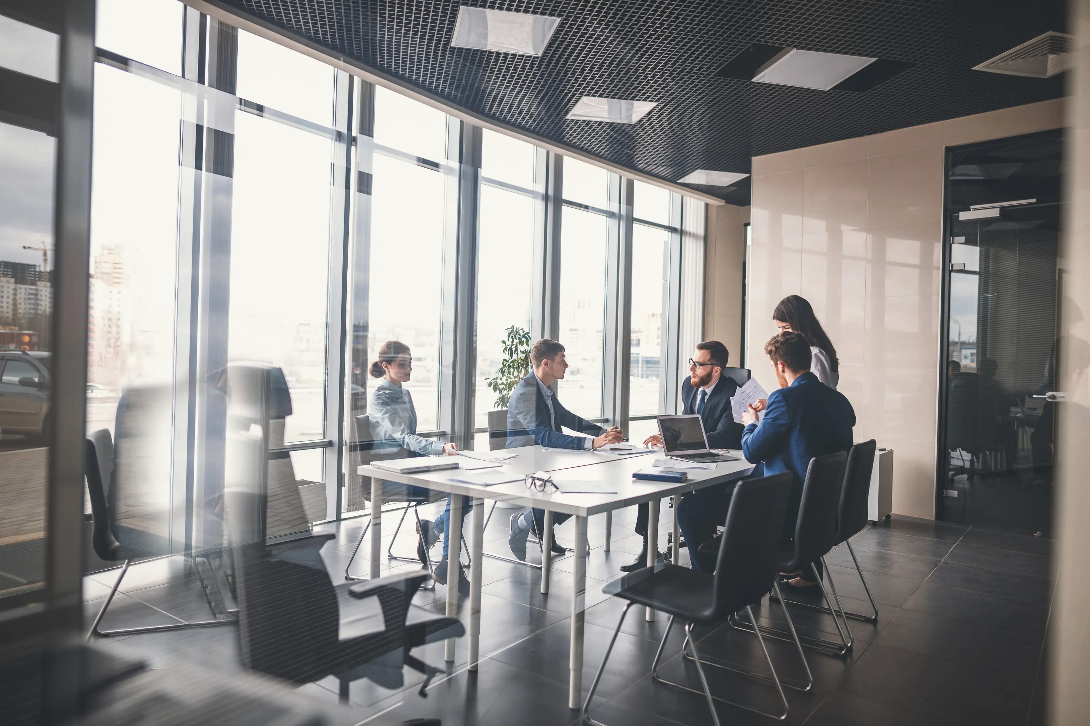 IT specialists immersed in their work, surrounded by technology in a modern office setting, where innovation meets efficiency.