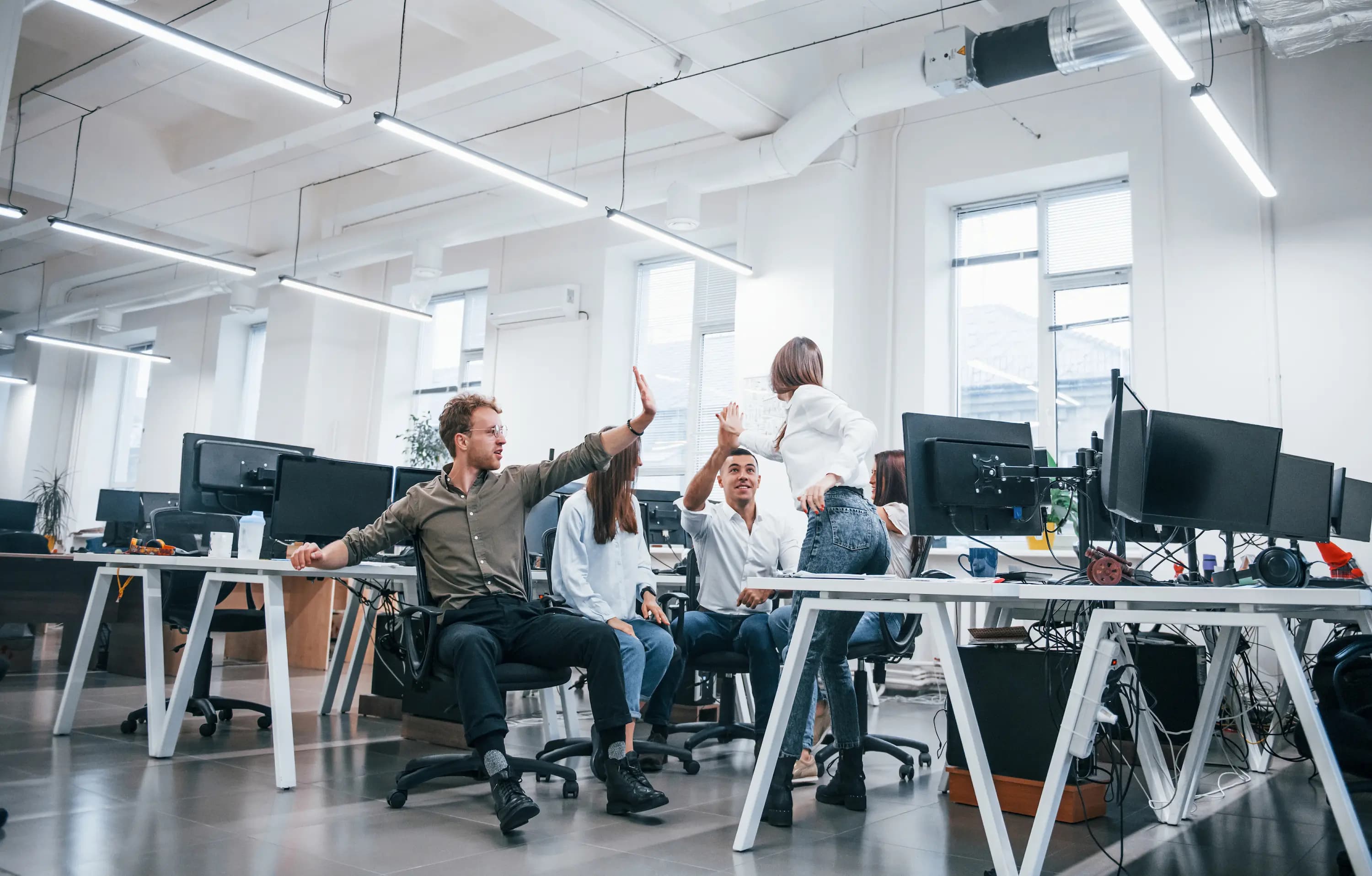 IT specialists immersed in their work, surrounded by technology in a modern office setting, where innovation meets efficiency.