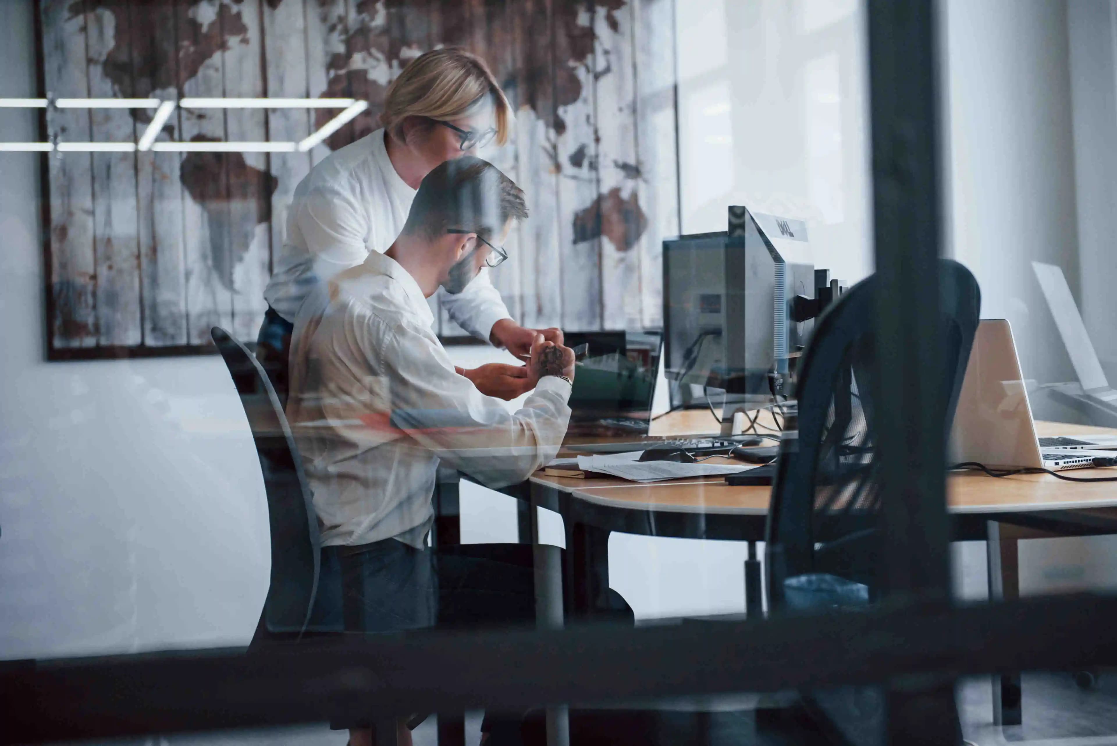 IT specialists immersed in their work, surrounded by technology in a modern office setting, where innovation meets efficiency.